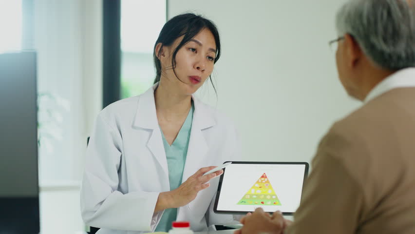 A doctor in a white coat explains the food pyramid, emphasizing healthy eating and lifestyle choices for better health.
