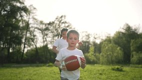 Child running with ball in park. Young boy runs throws football. Family fun outdoor activity child play catch. Kid joyfully runs active playtime. Child game of catch running joyfully with ball. - Powered by Shutterstock - Get 15% off with code: PIKWIZARD15