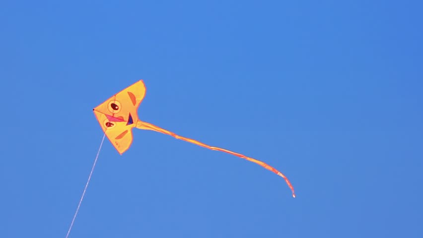 Colorful kite flying on the sky. Smiling cute kite
