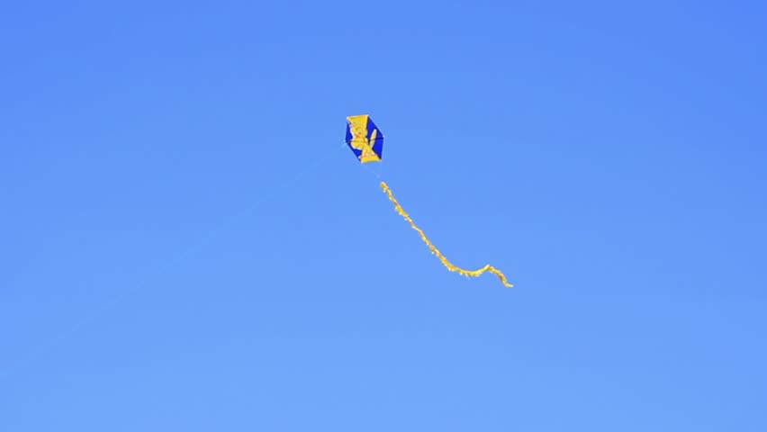 Flying kite against clear blue sky
