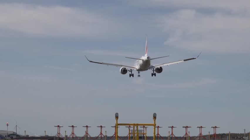 Stockholm, Sweden A commercial passenger aircraft lands on a sunny day at Arlanda airport.