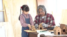 Asia retirement carpenter man and cheerful granddaughter enjoy create birdhouse toy in carpentry studio, aged people teaching woodwork skill to kids, family hobby lifestyle parenthood togetherness - Powered by Shutterstock - Get 15% off with code: PIKWIZARD15