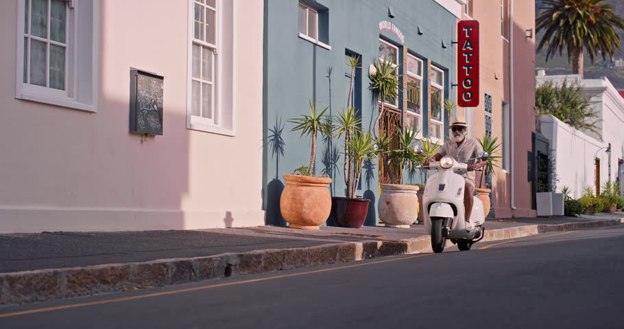 Black man, scooter and riding for travel, holiday and fun adventure in city road with sunglasses. Mature person, motorbike and rental for summer trip, vacation and journey with shades in Havana Cuba