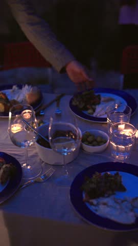 An Elegant Dinner Setting adorned with Romantic Candles and Exquisite Gourmet Dishes