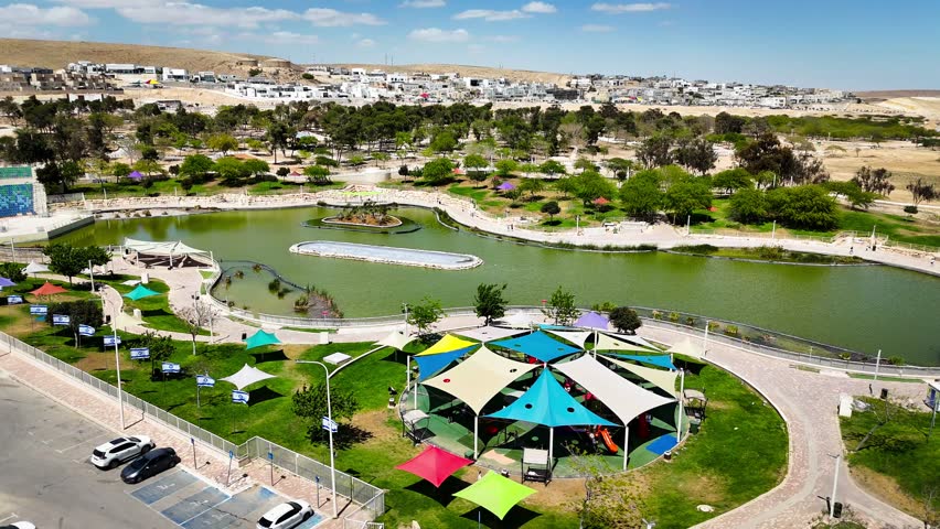 Drone Aerial View of Public Park and Lake in Dimona, Israel - Desert City Landscape
