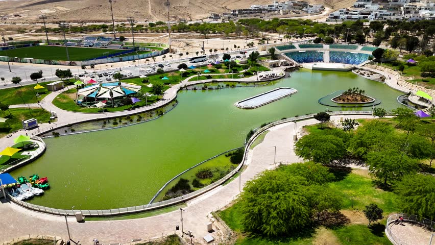 Drone Aerial View of Public Park and Lake in Dimona, Israel - Desert City Landscape
