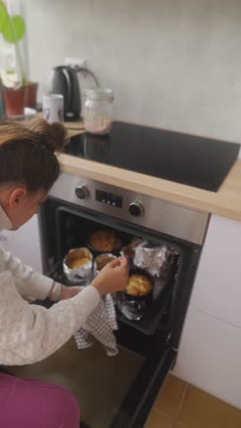 A Home Baker is Checking the Muffins as they Bake in the Oven for Perfection Unfolding