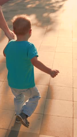 Children's leisure with dad. Cute child having fun with dad. Happy family. Kid son walking with father run on street. Carefree father child son enjoying walk on street. Happy kid boy run, child father
