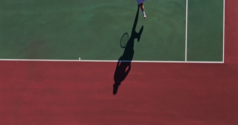Tennis court, person and exercise with serving for game, match or tournament in competition, play and activity. Training, outdoor sport and athlete with above for fitness, workout or challenge in UK