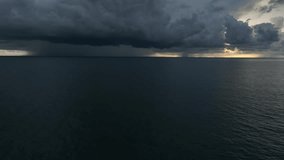 Captured from the sky, dark clouds loom over the ocean, as the storm builds in intensity, with rainfall starting to blur the horizon, signaling an impending downpour.
 - Powered by Shutterstock - Get 15% off with code: PIKWIZARD15