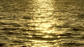 The drone captures the ocean's surface glistening with golden reflections, where sunlight dances across the water, creating a shimmering, ethereal glow.
 - Powered by Shutterstock - Get 15% off with code: PIKWIZARD15