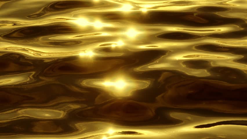 An aerial view of the ocean’s golden reflections brings a sense of serenity, where the gentle ripples of the water combine with the glowing light to create a peaceful, breathtaking landscape.
