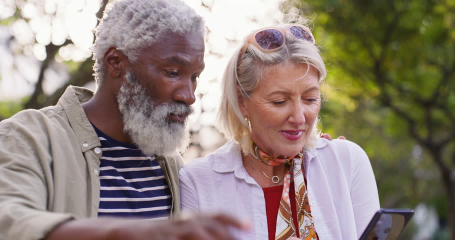 Senior couple, outdoor and communication with phone at restaurant for internet, connection and info. Happy, man and woman with tech at table for network, research and online review of food on website
