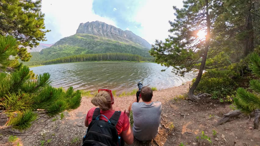 Us Sitting at Shore of Fishercap in Glacier National Park