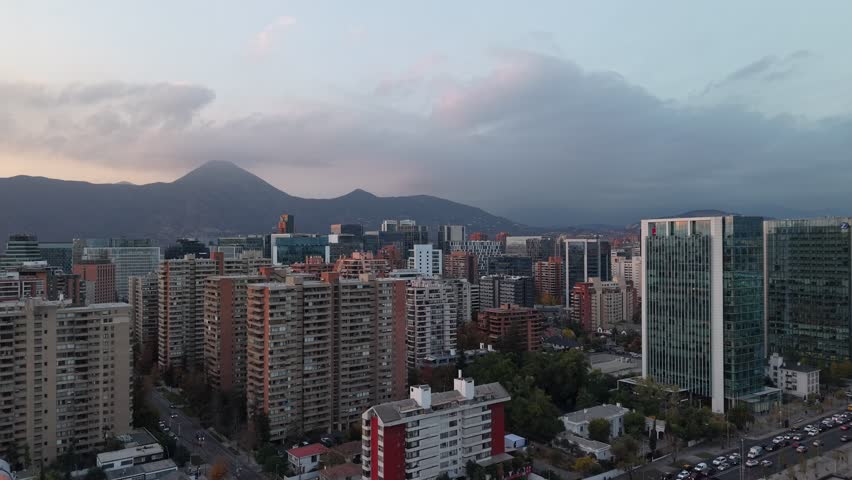 Stunning aerial shot capturing the dense architecture and bustling streets of Santiago, Chile during early evening.