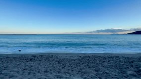 Calm ocean waves gently rolling onto a sandy beach, creating a peaceful and relaxing scene. - Powered by Shutterstock - Get 15% off with code: PIKWIZARD15