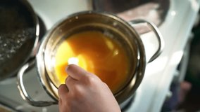 Slow-motion video of honey and butter melting together in a glass bowl over a steam bath for pie filling preparation - Powered by Shutterstock - Get 15% off with code: PIKWIZARD15