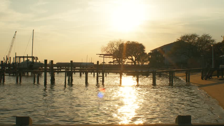 Sunset Over docks with sand and boats 