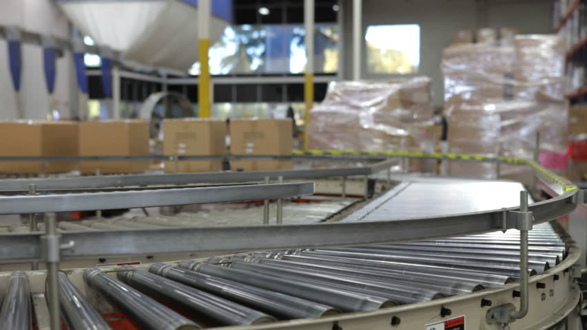 Boxes move along conveyor belt towards camera in time lapse sequence. Shot on Canon 5d Mk2 with a frame rate of 30fps