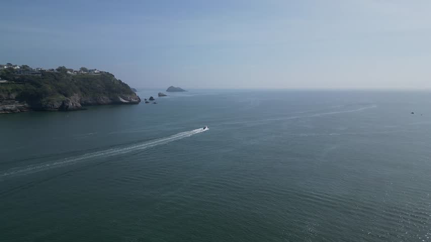 Torbay, South Devon, England: DRONE VIEWS: A speedboat heads across the bay in the direction of Thatcher Rock. Torbay is a popular UK holiday destination and a magnet for water sports enthusiasts.