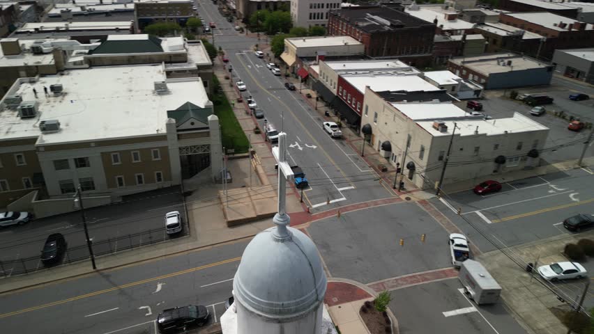 Aerial close up circling on cross on church steeple in town of Lenoir North Carolina in Blue Ridge Mountains