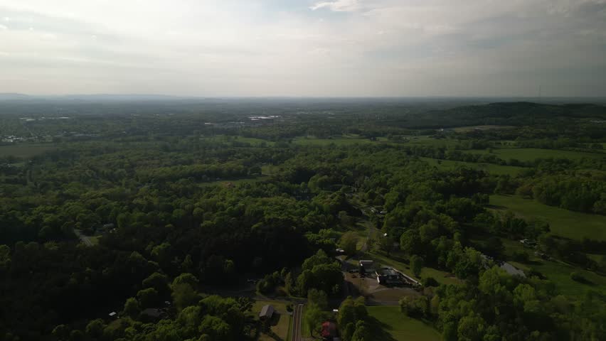 Aerial of rural mountain homes and pond in forest near Chatsworth Georgia near Cohutta wilderness