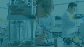 Electronics researchers soldering circuit board in lab, presenting animated data chart overlays. Technology, innovation, collaboration, engineering, prototyping, precision, creativity - Powered by Shutterstock - Get 15% off with code: PIKWIZARD15