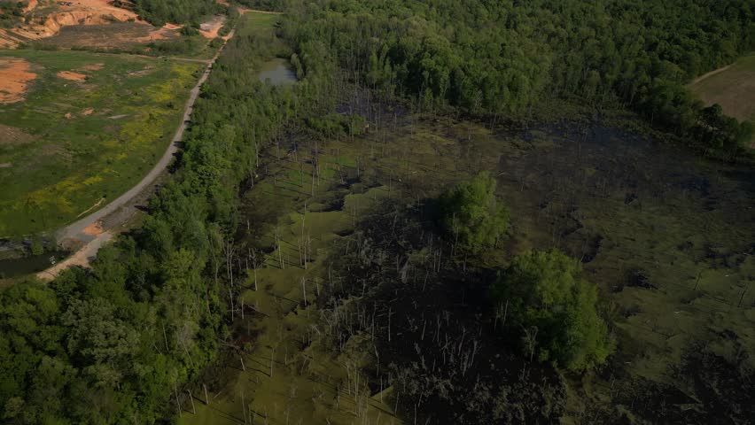 Aerial of swamp water reveal to horizon and rural farm land in Tennessee near Chattanooga