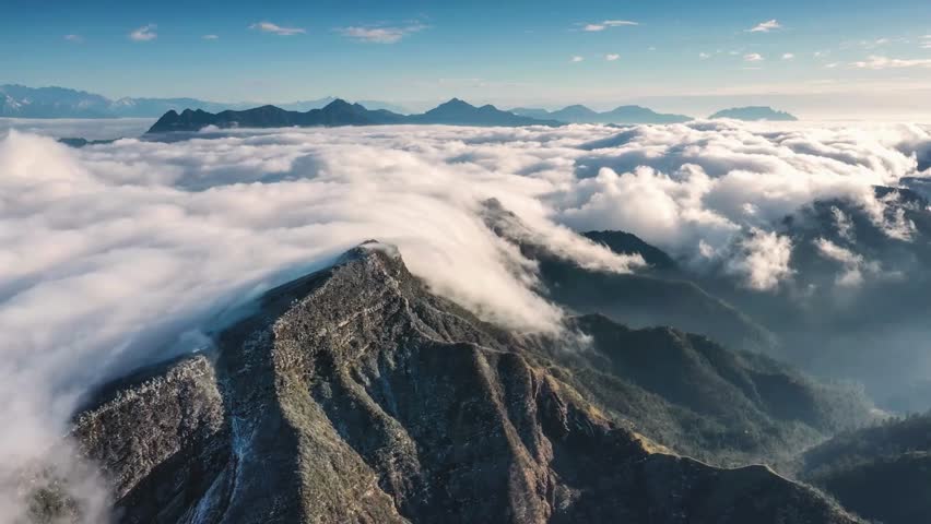 Majestic Mountain Peaks Above a Sea of Clouds at Sunrise