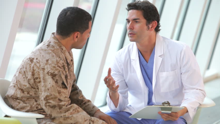 Doctor comforts soldier in uniform suffering from post traumatic stress disorder. Shot on Canon 5d Mk2 with a frame rate of 30fps