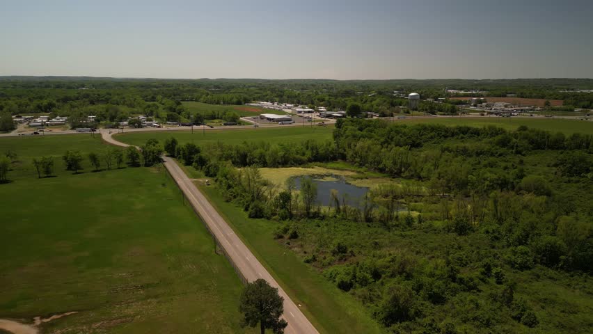 Aerial over swampy rural farm land in Alabama in springtime along highway 72
