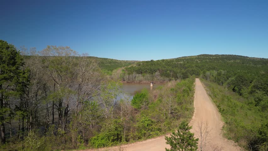 Aerial reveal Brock Creek lake in Ozark National forest with flooded water in spring
