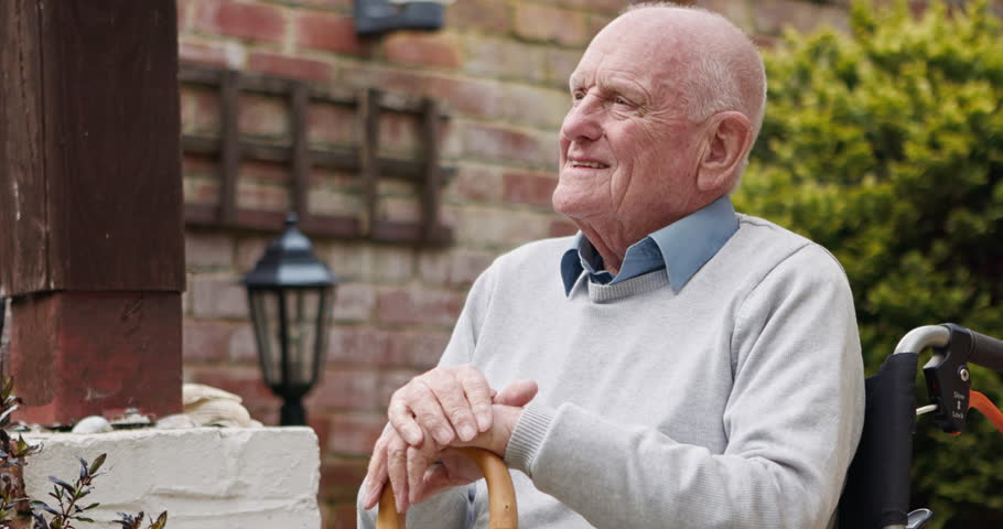 Thinking, garden and face of senior man outdoors for relax, fresh air and wellness at home. Retirement, nature and portrait of elderly person smile with walking stick, wheelchair and calm in backyard