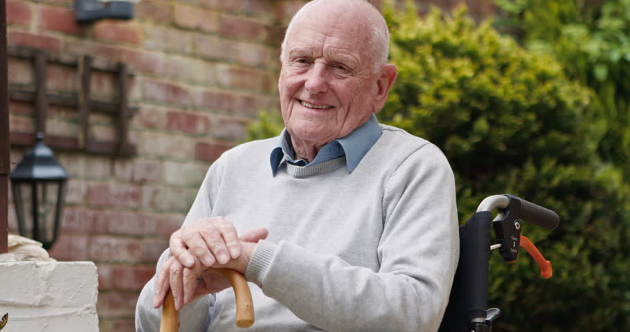 Thinking, garden and face of senior man outdoors for relax, fresh air and wellness at home. Retirement, nature and portrait of elderly person smile with walking stick, wheelchair and calm in backyard