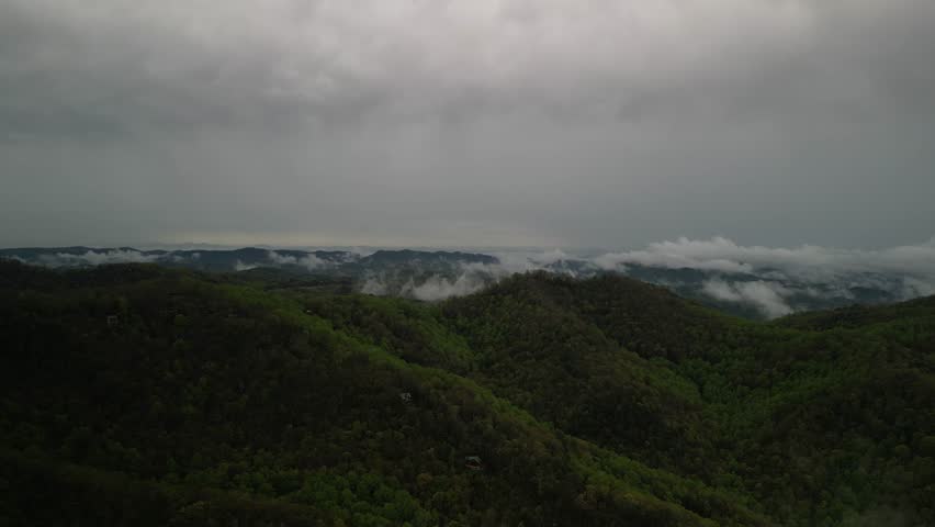 High aerial of southern Appalachian Mountains with low clouds in Blowing Rock North Carolina