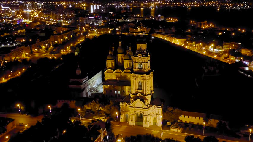 Dolly zoom. Astrakhan, Russia. Bell tower of the Astrakhan Kremlin. The Astrakhan Kremlin is a white stone fortress built in the 16th century. Night, Aerial View, Departure of the camera