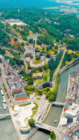 Vertical video. Namur, Belgium. Citadelle de Namur - 10th-century fortress with a park, rebuilt several times. Panorama of the central part of the city. River Meuse. Summer day, Aerial View, Point of