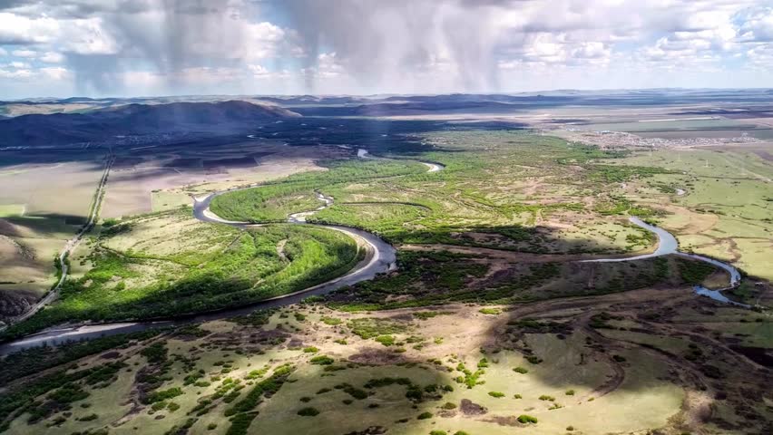 Aerial View of Winding Road Through Grassy Landscape