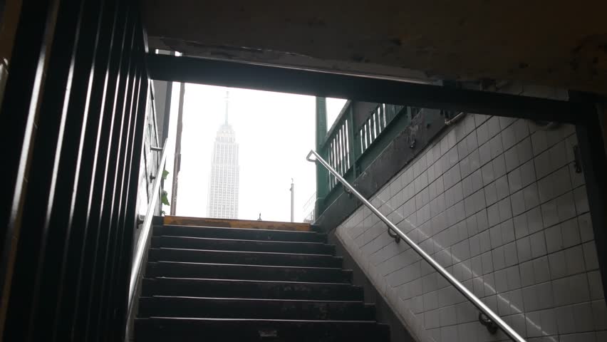 New York City underground subway metro. Empire State building. Metropolitan entrance or exit stairway, Manhattan, 34 street. NYC Midtown financial business district. Public transport station stairs.