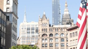 New York City Manhattan Midtown street architecture. Empire State building, iconic high-rise skyscraper, USA. American flag and urban cityscape, famous NYC tower, United States. Union Square, Broadway - Powered by Shutterstock - Get 15% off with code: PIKWIZARD15