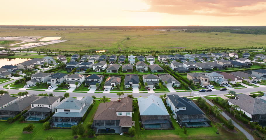 Premium housing development in the USA. Expensive houses between green palm trees in southwest Florida