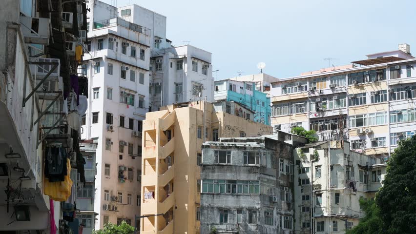 Residential buildings in a densely populated, low-income neighborhood of Hong Kong, China, highlighting urban housing conditions.