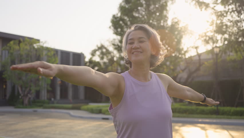 Asia adult aged people middle age mindful happy old woman yoga body pose zen calm stress relief outdoor nature public park sun light self love relax elder aging life asian female mental health care.