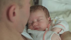 Young neo father with his sleep newborn baby, closeup shot. Concept of children and baby, parenthood - Powered by Shutterstock - Get 15% off with code: PIKWIZARD15