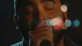 Bearded man holding microphone in music studio showing animated soundwave and graph icon. Portrait, performance, moody, atmospheric, nightlife, music, creativity - Powered by Shutterstock - Get 15% off with code: PIKWIZARD15