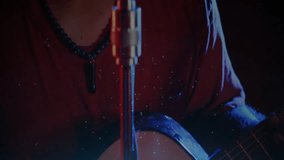 Male singer performing on music stage, with retro microphone, red blue lights, floating drops. Performance, vocalist, nightlife, concert, entertainment, dramatic, vibrant - Powered by Shutterstock - Get 15% off with code: PIKWIZARD15