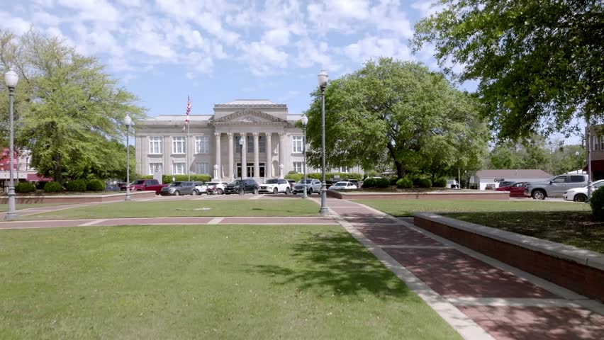Covington County Courthouse in downtown Andalusia, Alabama with drone video moving up.