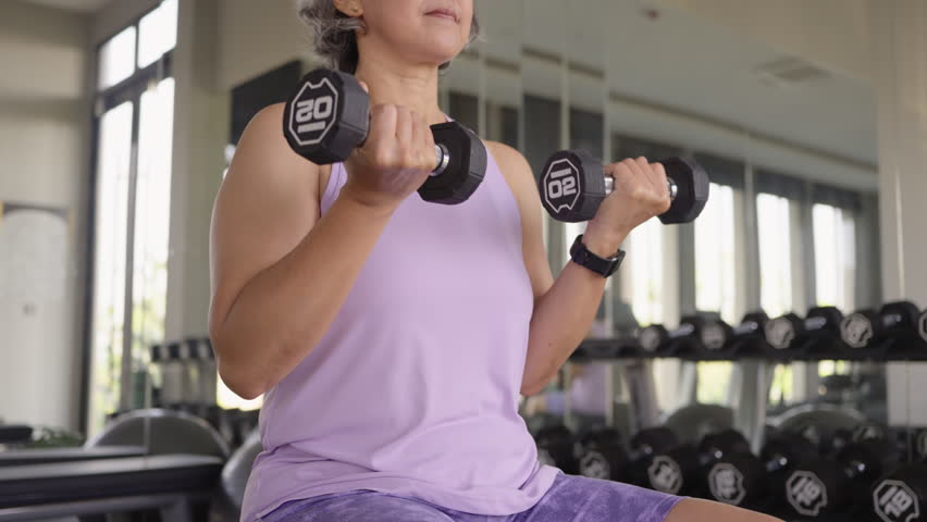 Asia adult aged people middle age happy old woman gym workout body weight arm picking up lift dumbbell self love protect elder aging life asian female. Health care older club sport build muscle mass.