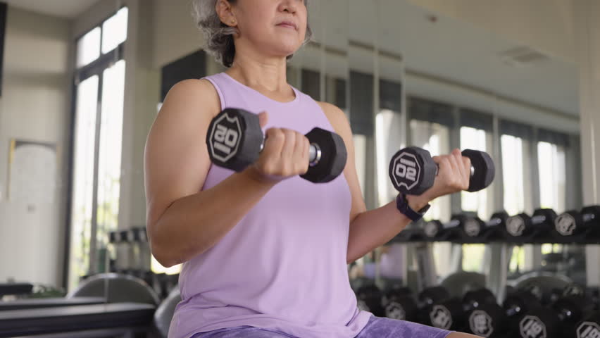 Asia adult aged people middle age happy old woman gym workout body weight arm picking up lift dumbbell self love protect elder aging life asian female. Health care older club sport build muscle mass.