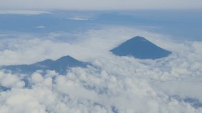 Stunning aerial view of volcanic peaks piercing through cloud layers above Bali, Indonesia. - Powered by Shutterstock - Get 15% off with code: PIKWIZARD15